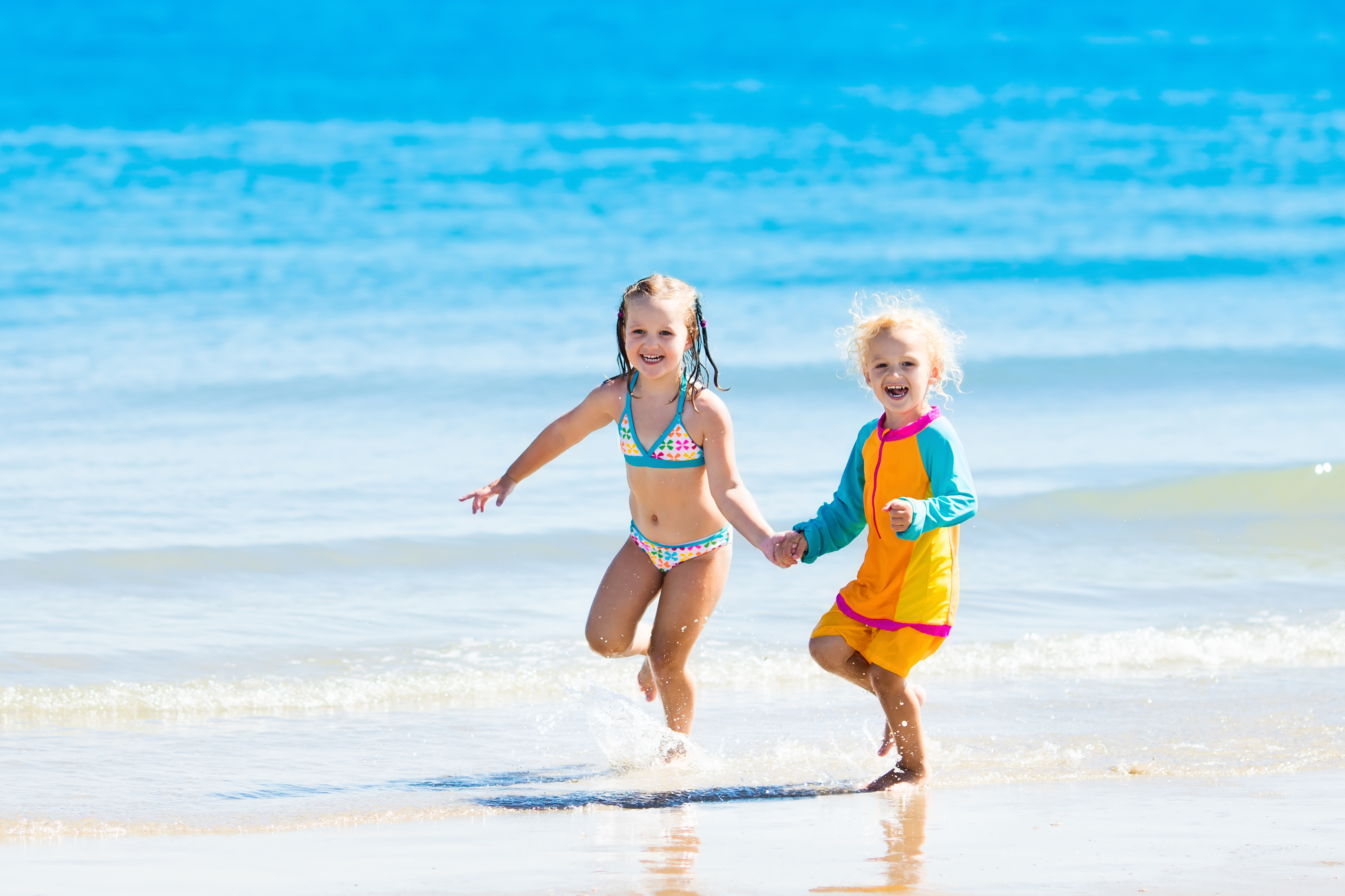 Two children playing in the water on their Destin vacation