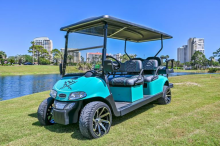 Golf cart sitting outside on the grass